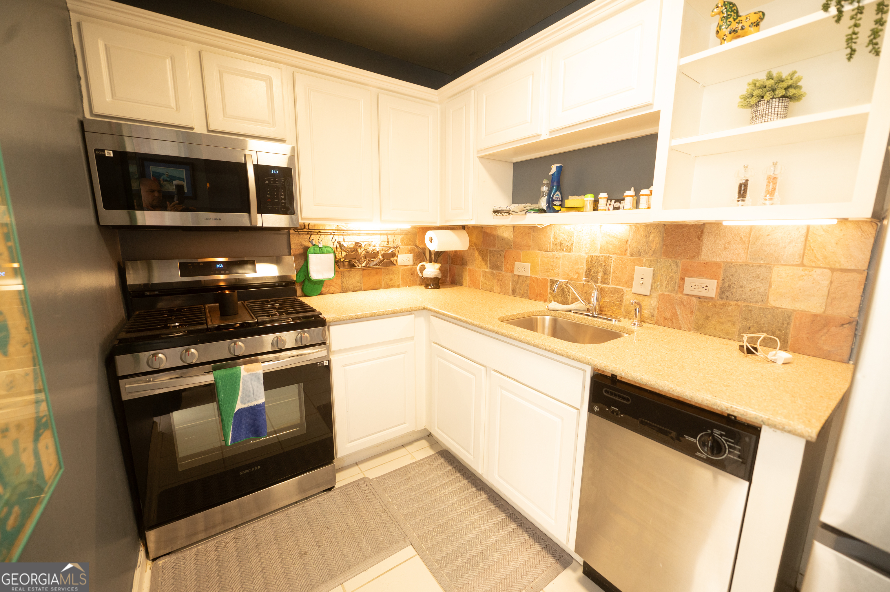 620 Peachtree Street Northeast, Unit 1501 Atlanta, GA 30308 - Photo 8 of 18 a kitchen with stainless steel appliances a stove microwave and sink