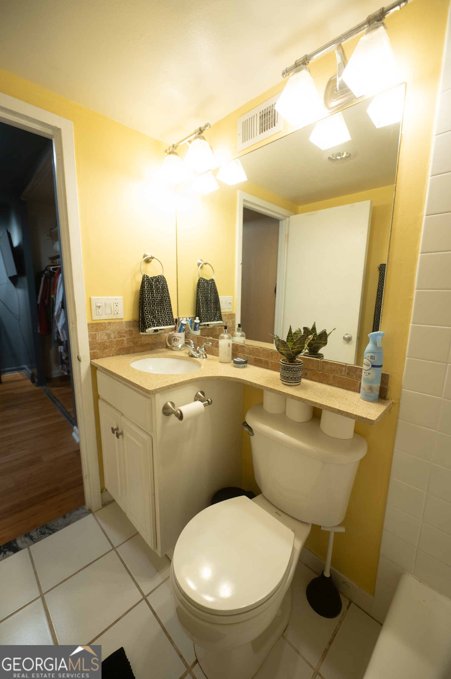 620 Peachtree Street Northeast, Unit 1501 Atlanta, GA 30308 - Photo 9 of 18 a bathroom with a toilet sink and mirror