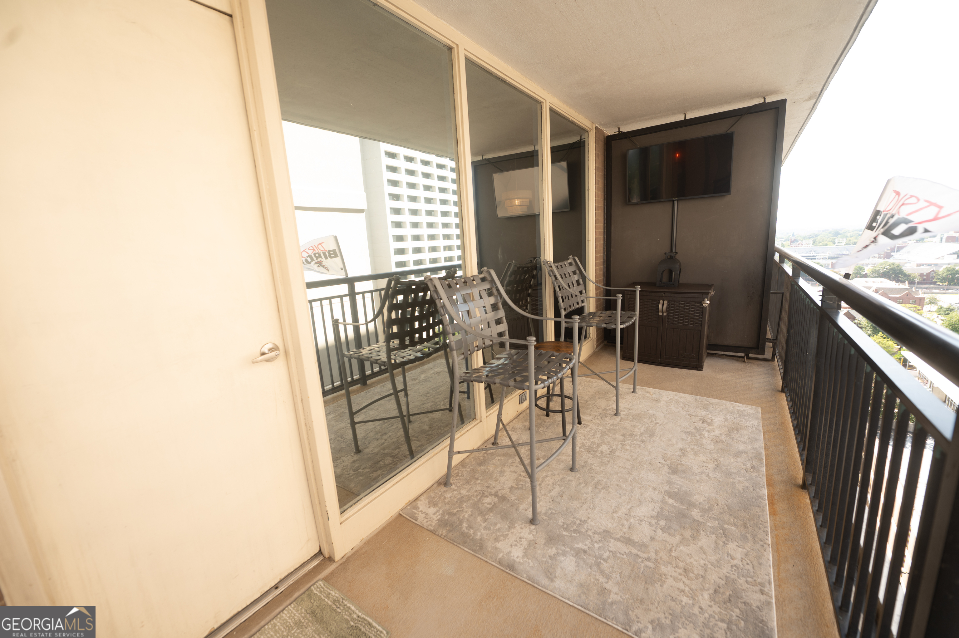 620 Peachtree Street Northeast, Unit 1501 Atlanta, GA 30308 - Photo 10 of 18 a living room with furniture and a flat screen tv