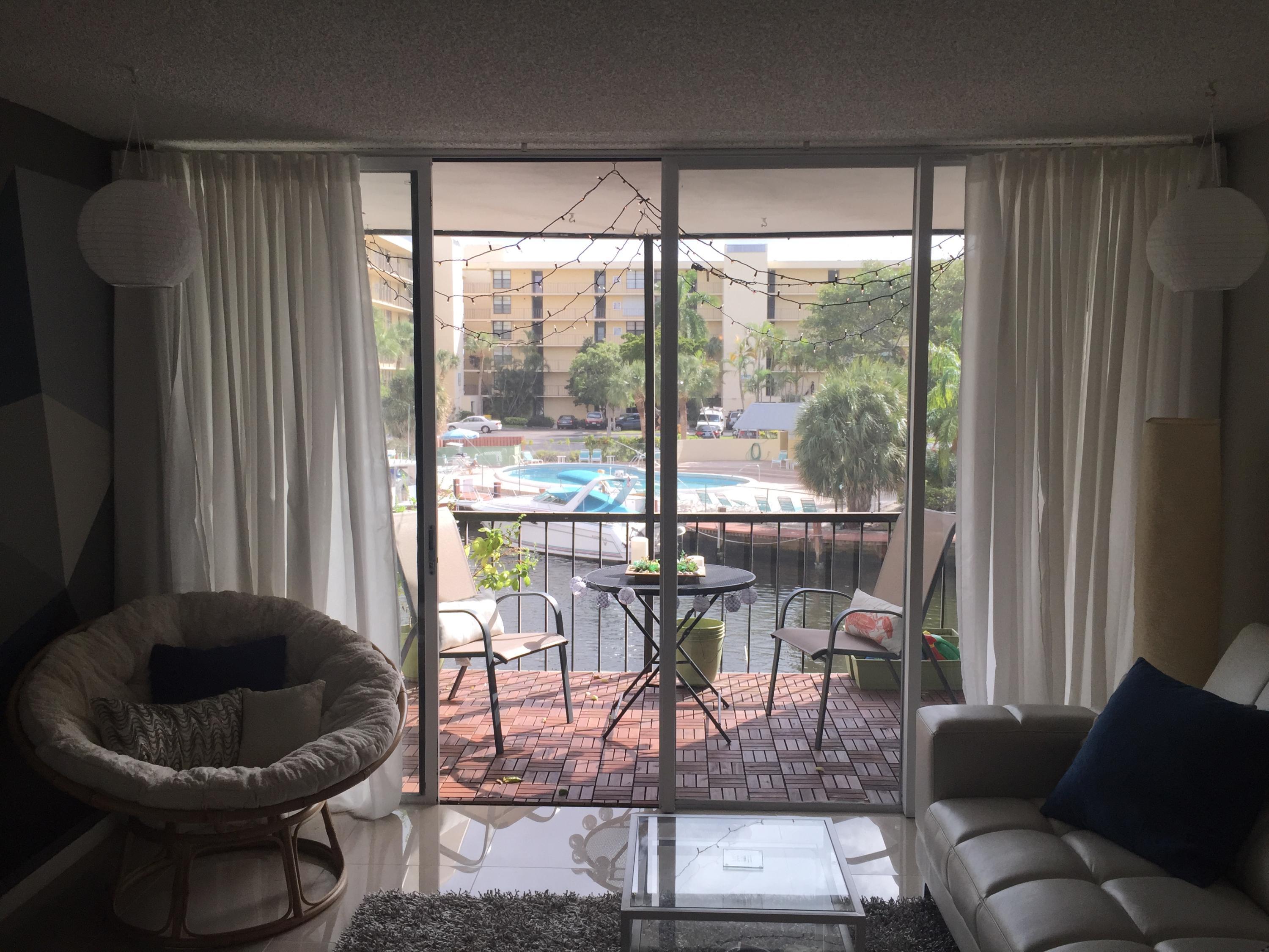 10 Royal Palm Way, Unit 2030 Boca Raton, FL 33432 - Photo 14 of 26 a living room with furniture and a large window