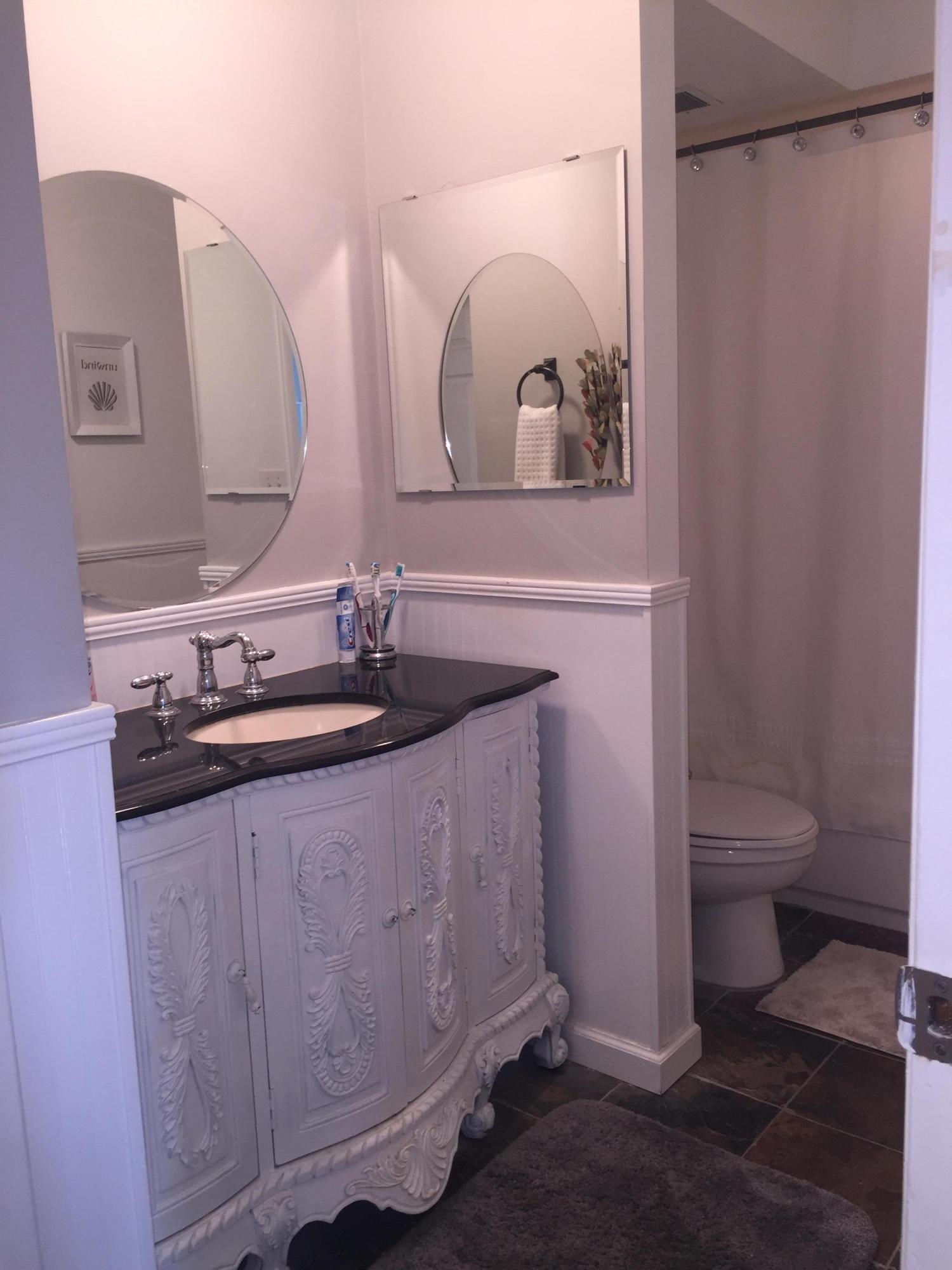 10 Royal Palm Way, Unit 2030 Boca Raton, FL 33432 - Photo 22 of 26 a bathroom with a granite countertop sink a toilet and a mirror