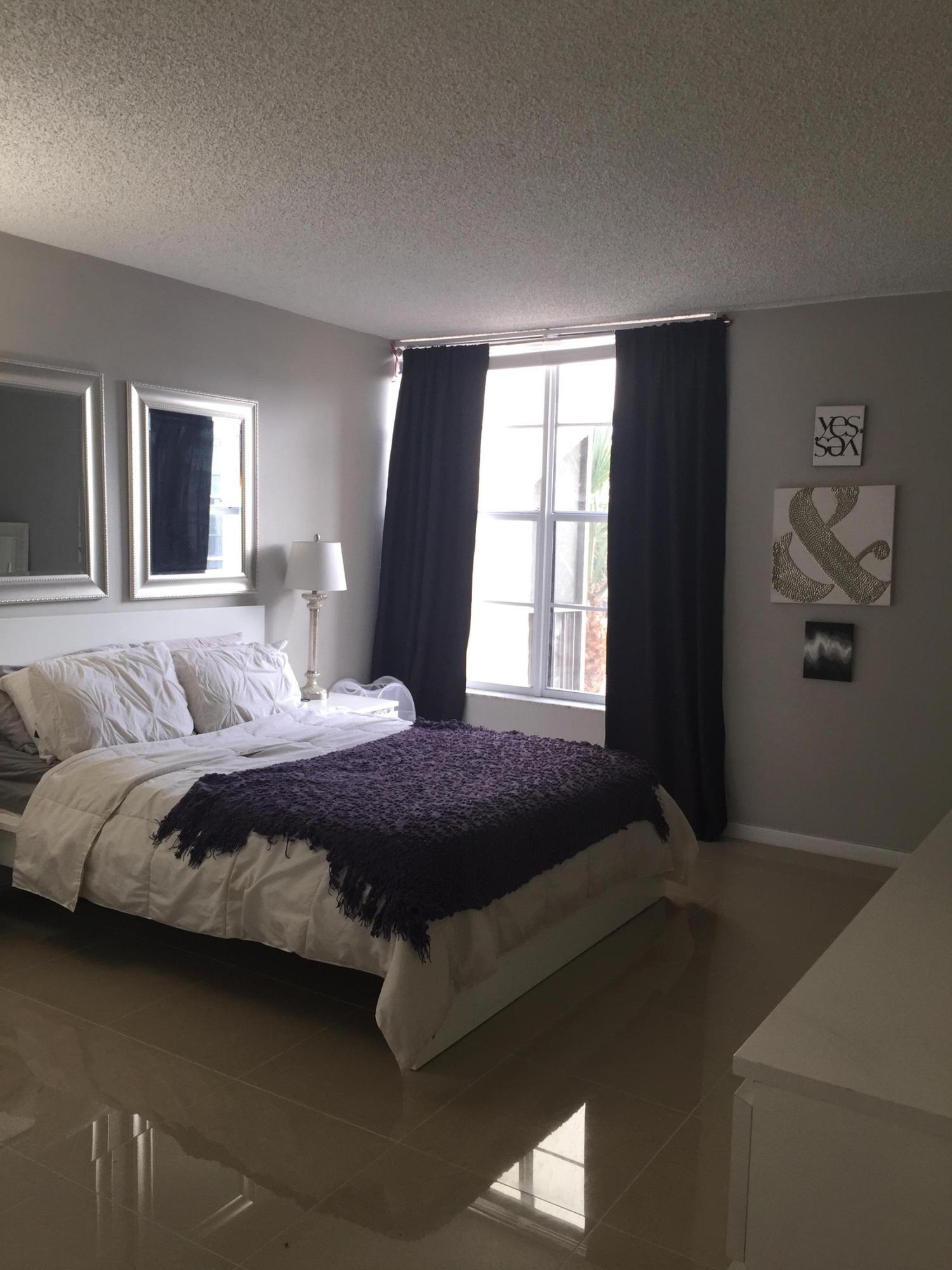 10 Royal Palm Way, Unit 2030 Boca Raton, FL 33432 - Photo 23 of 26 a bedroom with a bed and window