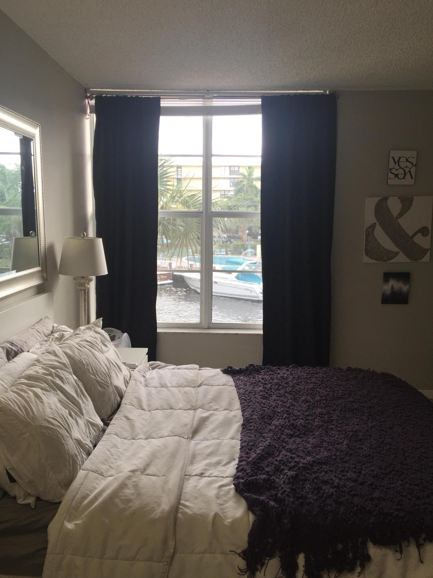 10 Royal Palm Way, Unit 2030 Boca Raton, FL 33432 - Photo 24 of 26 a bedroom with a bed and a large window
