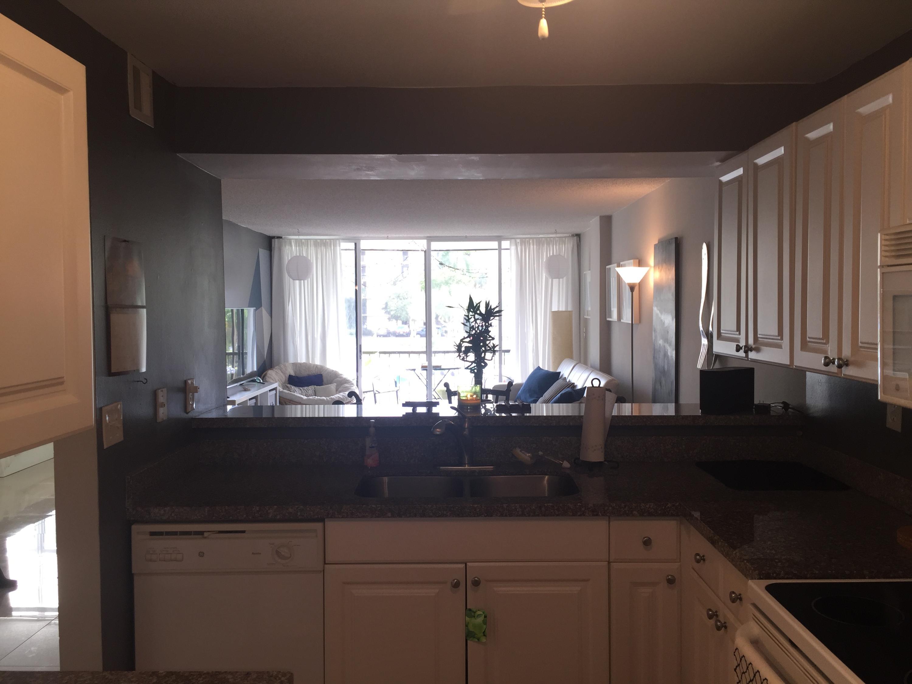 10 Royal Palm Way, Unit 2030 Boca Raton, FL 33432 - Photo 7 of 26 a view of kitchen with granite countertop a sink and cabinets