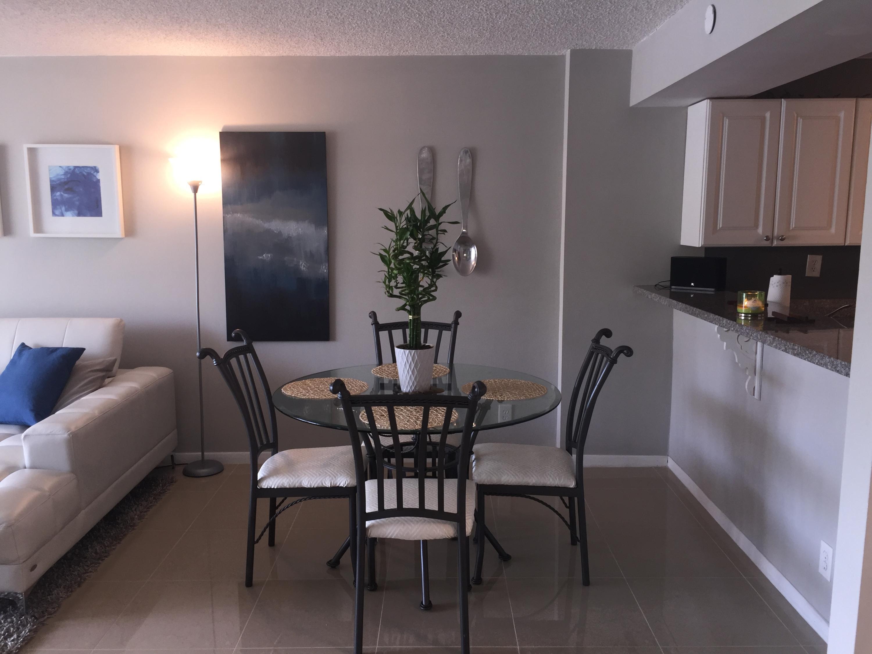 10 Royal Palm Way, Unit 2030 Boca Raton, FL 33432 - Photo 9 of 26 a view of a dining room with furniture and wooden floor