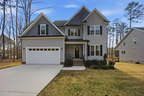 a front view of a house with a yard