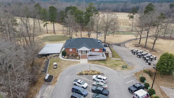 an aerial view of a house with a mountain
