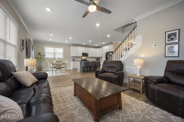 a living room with furniture a flat screen tv and a fireplace
