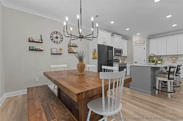 a kitchen with a table chairs refrigerator and microwave