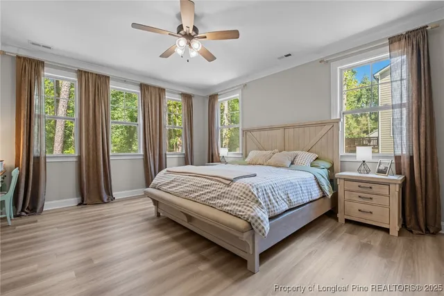 a bedroom with a large bed and a chandelier