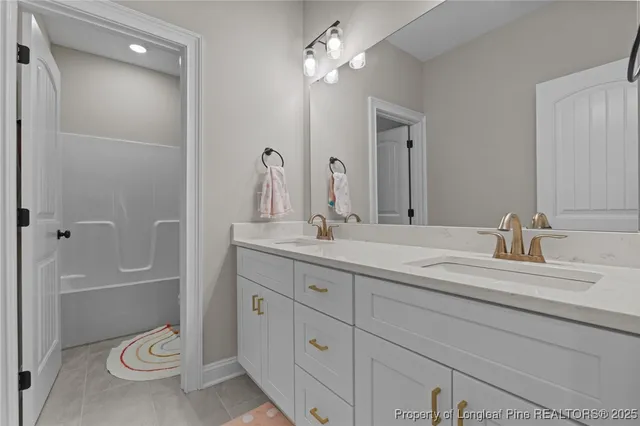 a bathroom with a granite countertop sink a toilet and a large mirror