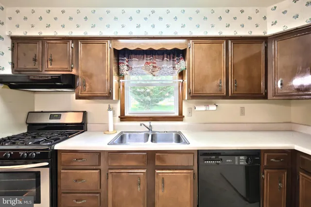 a kitchen with a table chairs refrigerator and microwave