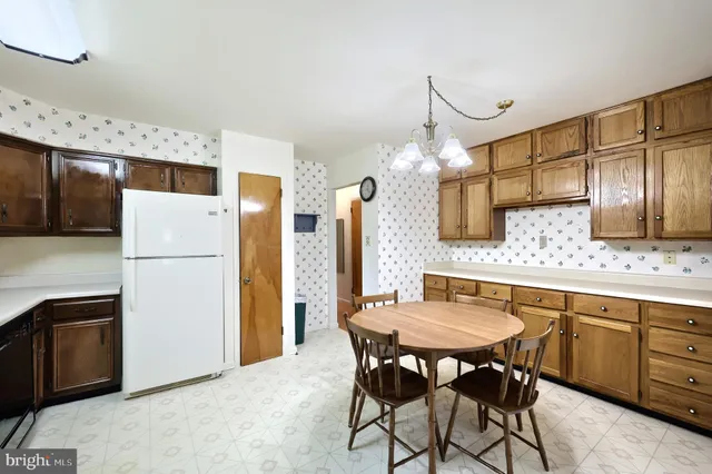 a kitchen with granite countertop a sink stove and refrigerator