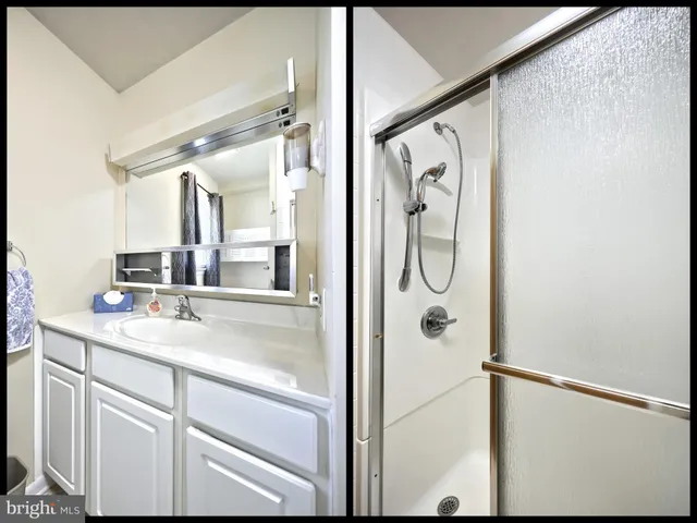 a view of walk in closet with empty tub and wooden floor