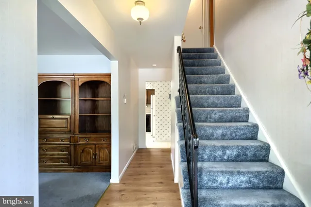 a large bedroom with a bed and a chandelier