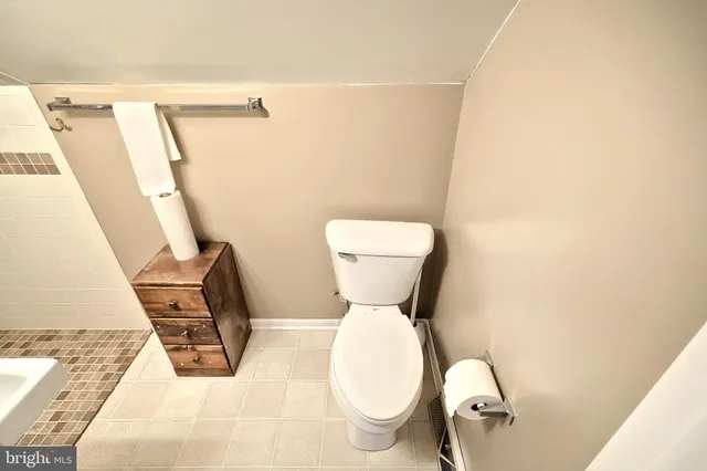 a bathroom with a sink toilet and mirror