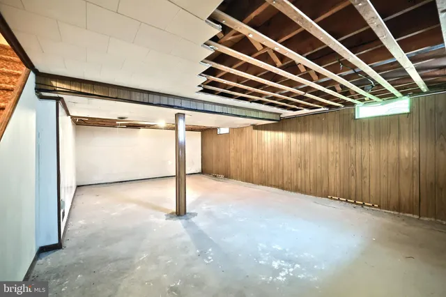 an aerial view of a residential houses with outdoor space and trees