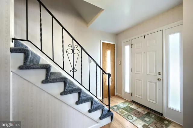 a view of entryway with wooden floor and stairs