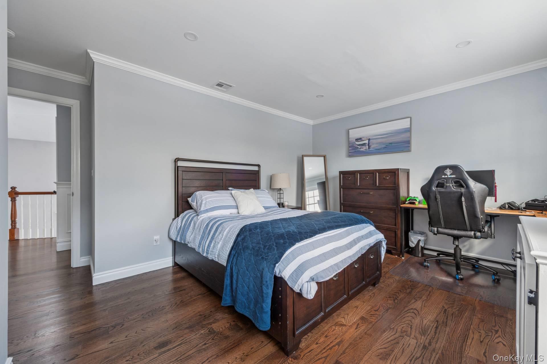 47 Bathing Beach Road Southampton, NY 11968 - Photo 16 of 20 a bedroom with a bed a table and wooden floor