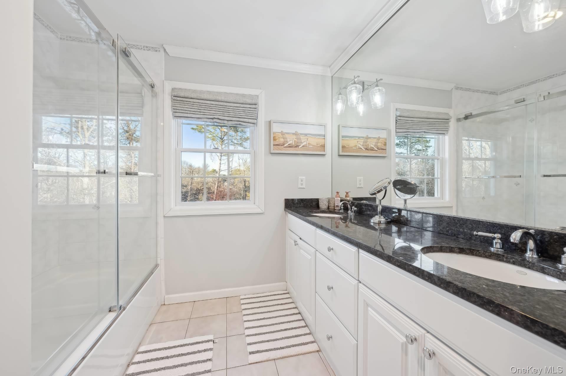 47 Bathing Beach Road Southampton, NY 11968 - Photo 17 of 20 a bathroom with a double vanity sink and a mirror