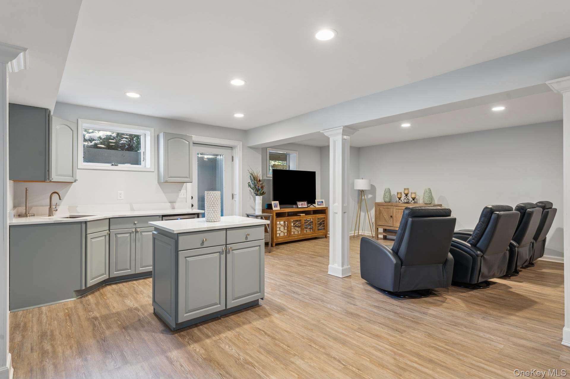 47 Bathing Beach Road Southampton, NY 11968 - Photo 18 of 20 a large living room with stainless steel appliances granite countertop a couch and a flat screen tv