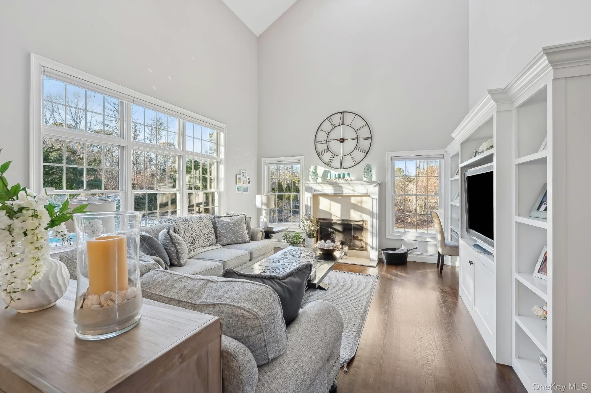 47 Bathing Beach Road Southampton, NY 11968 - Photo 4 of 20 a living room with furniture a flat screen tv and a large window