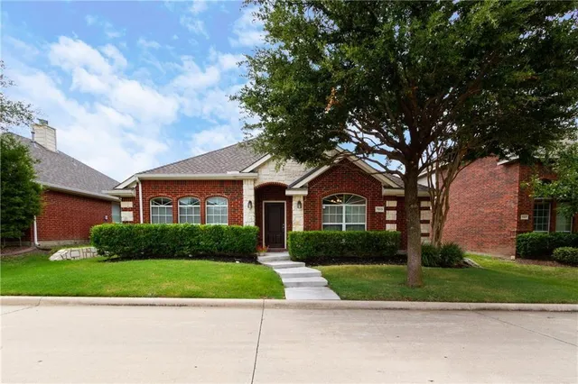 a front view of a house with a yard and a garage