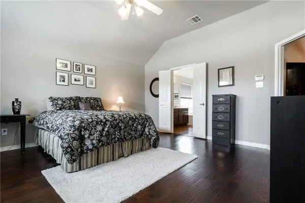 a bedroom with a large bed and a large window