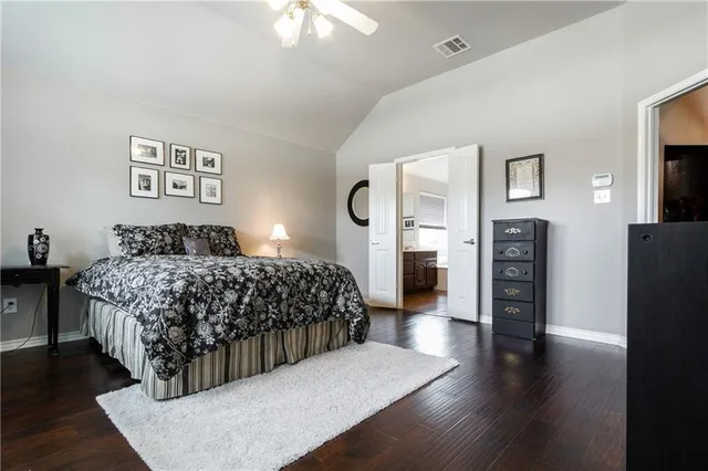 a bedroom with a large bed and a large window