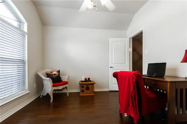 a livingroom with lounge chair and a window