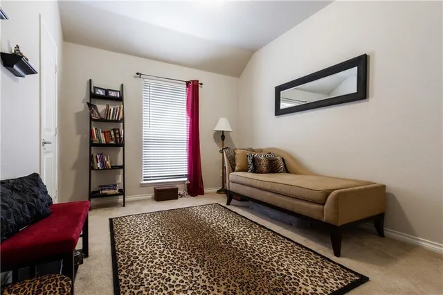 a bedroom with bed and a mirror