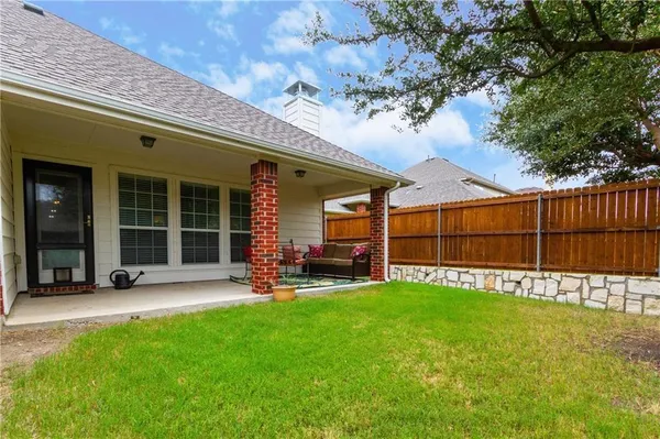 a balcony with chairs and a potted plant