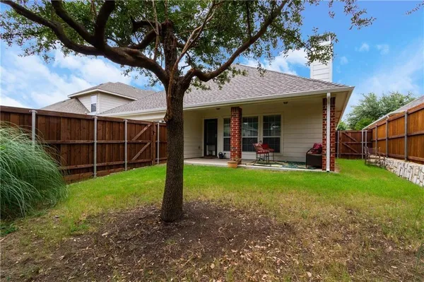 a view of a chair and table in front of a house