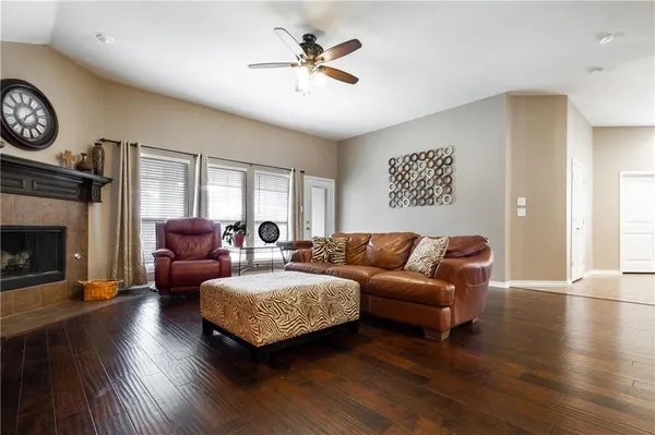 a living room with furniture a fireplace and a large window