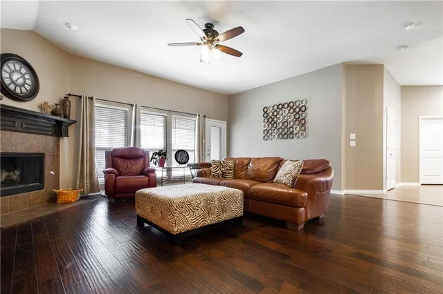 a living room with furniture a fireplace and a large window