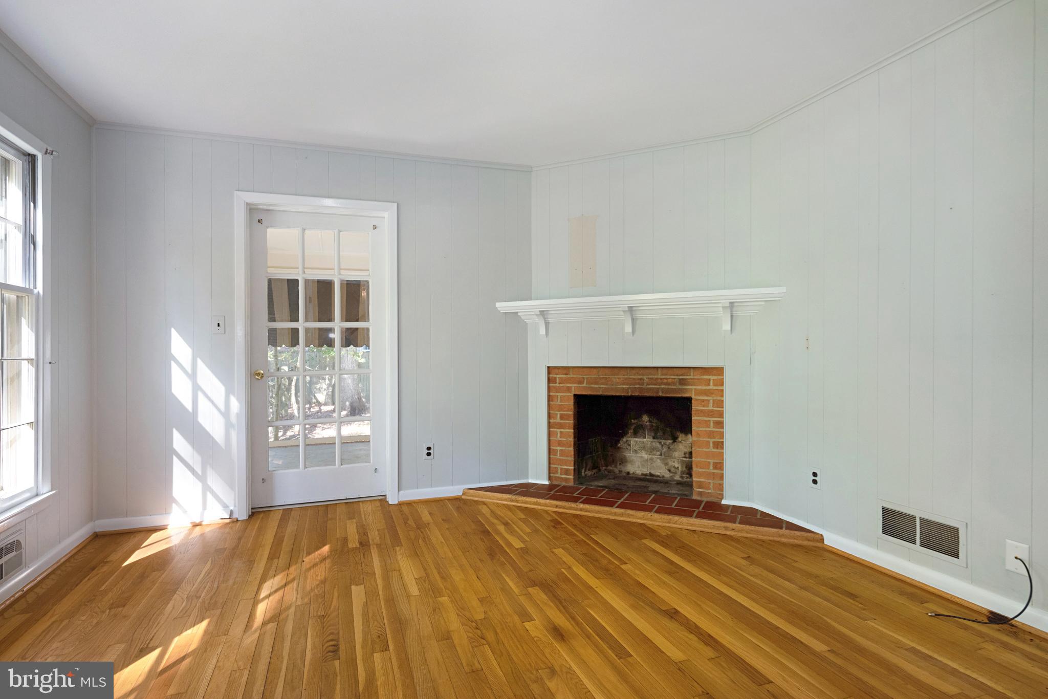 1619 Ridout Road Annapolis, MD 21409 - Photo 13 of 37 Den and Door to screened porch wood burning FP