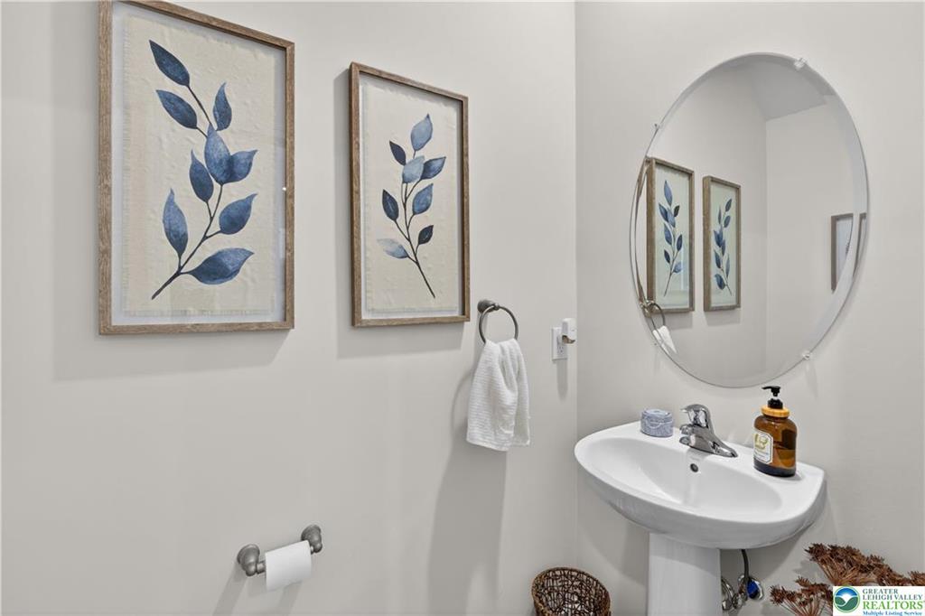 1274 Martin Road Breinigsville, PA 18031 - Photo 9 of 18 A classic pedestal sink sits beneath an oval wall mirror in this powder room.