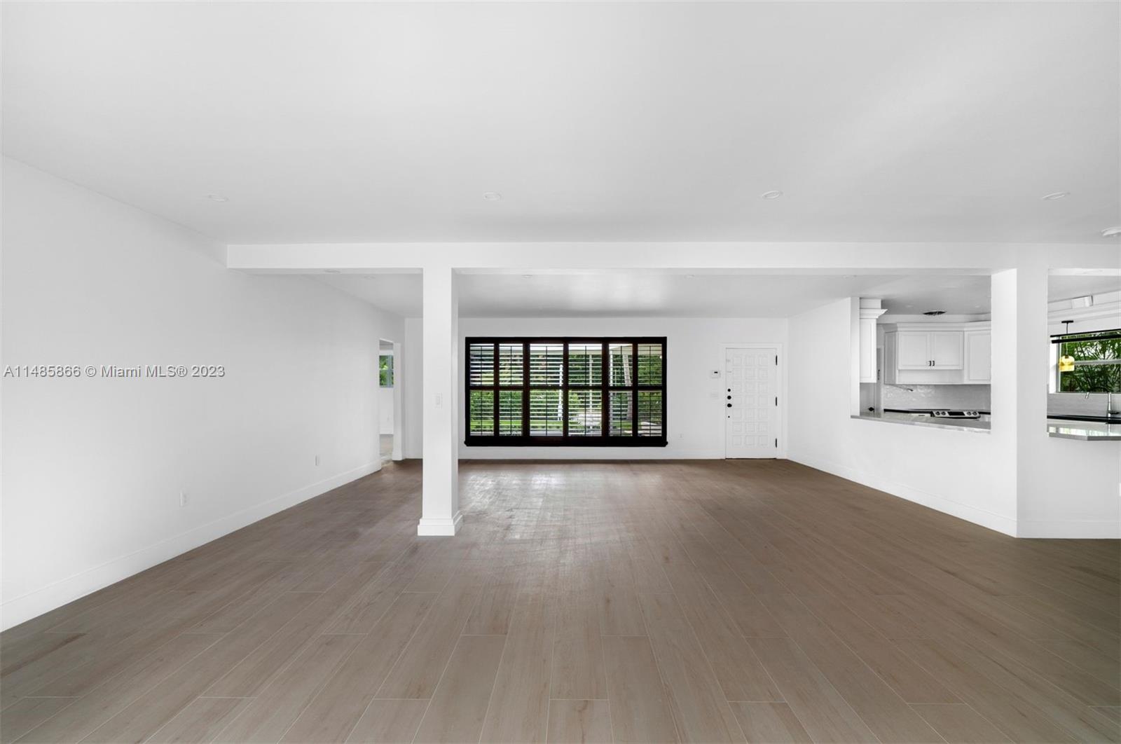 2385 North Bay Road Miami Beach, FL 33140 - Photo 11 of 36 a view of empty room with wooden floor and fan