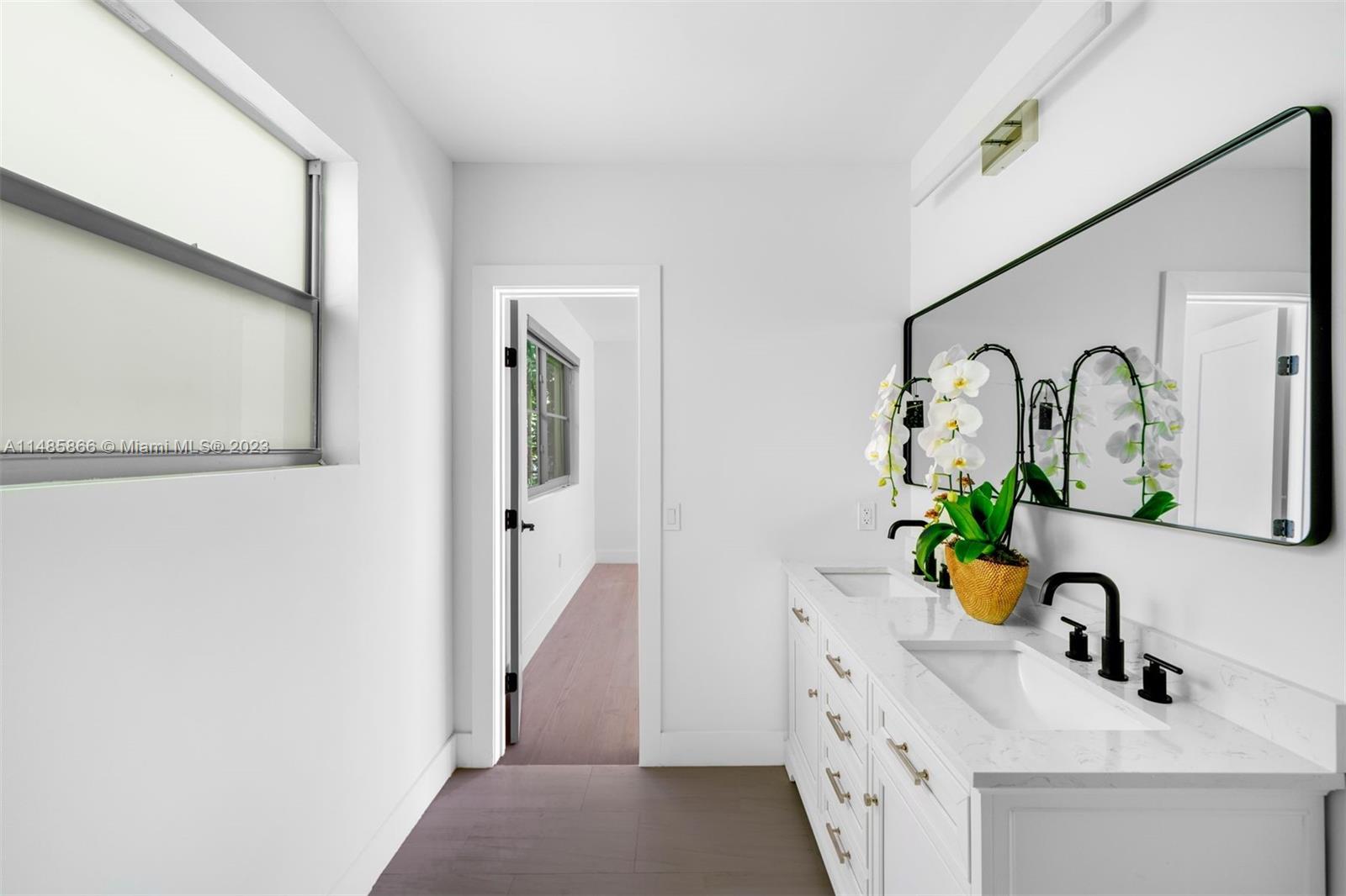 2385 North Bay Road Miami Beach, FL 33140 - Photo 17 of 36 a bathroom with a sink and a mirror