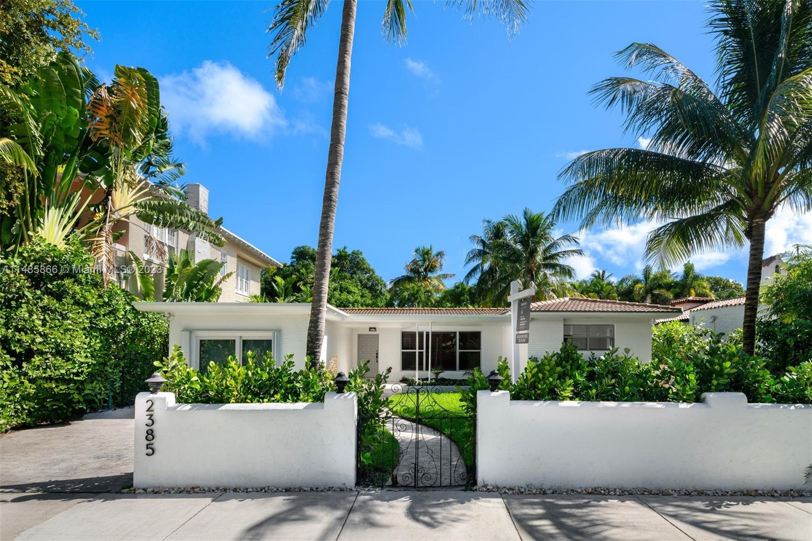 2385 North Bay Road Miami Beach, FL 33140 - Photo 2 of 36 front view of a house with a garden