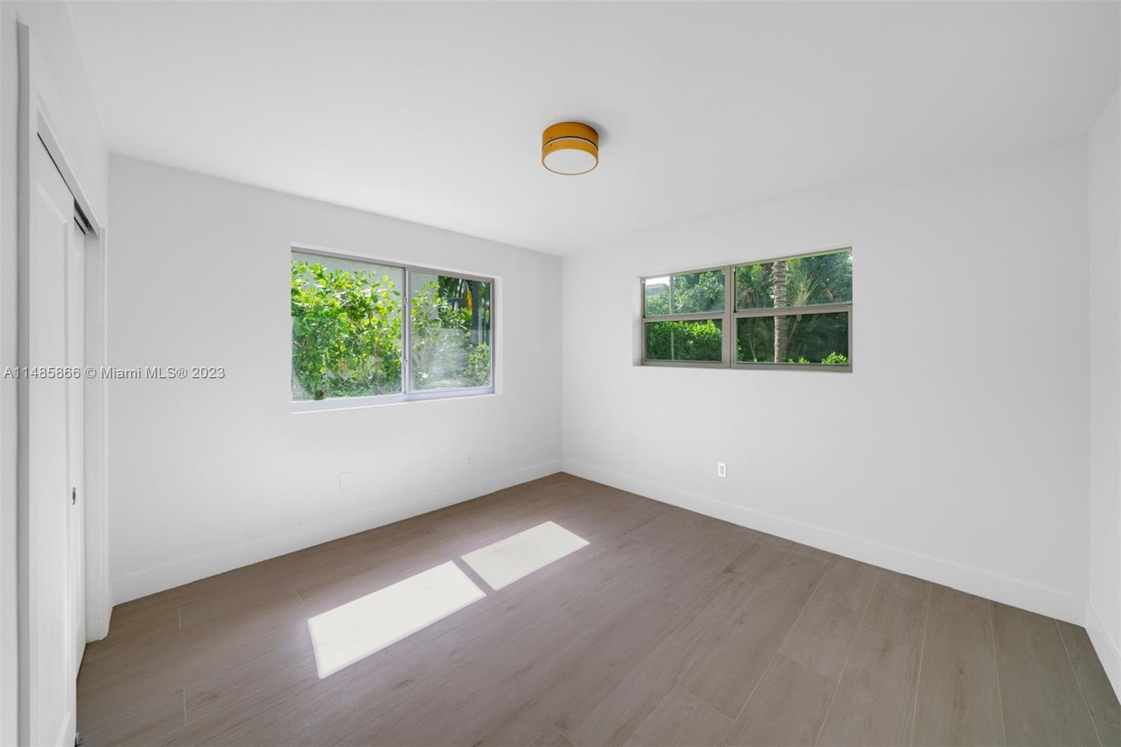 2385 North Bay Road Miami Beach, FL 33140 - Photo 21 of 36 an empty room with windows