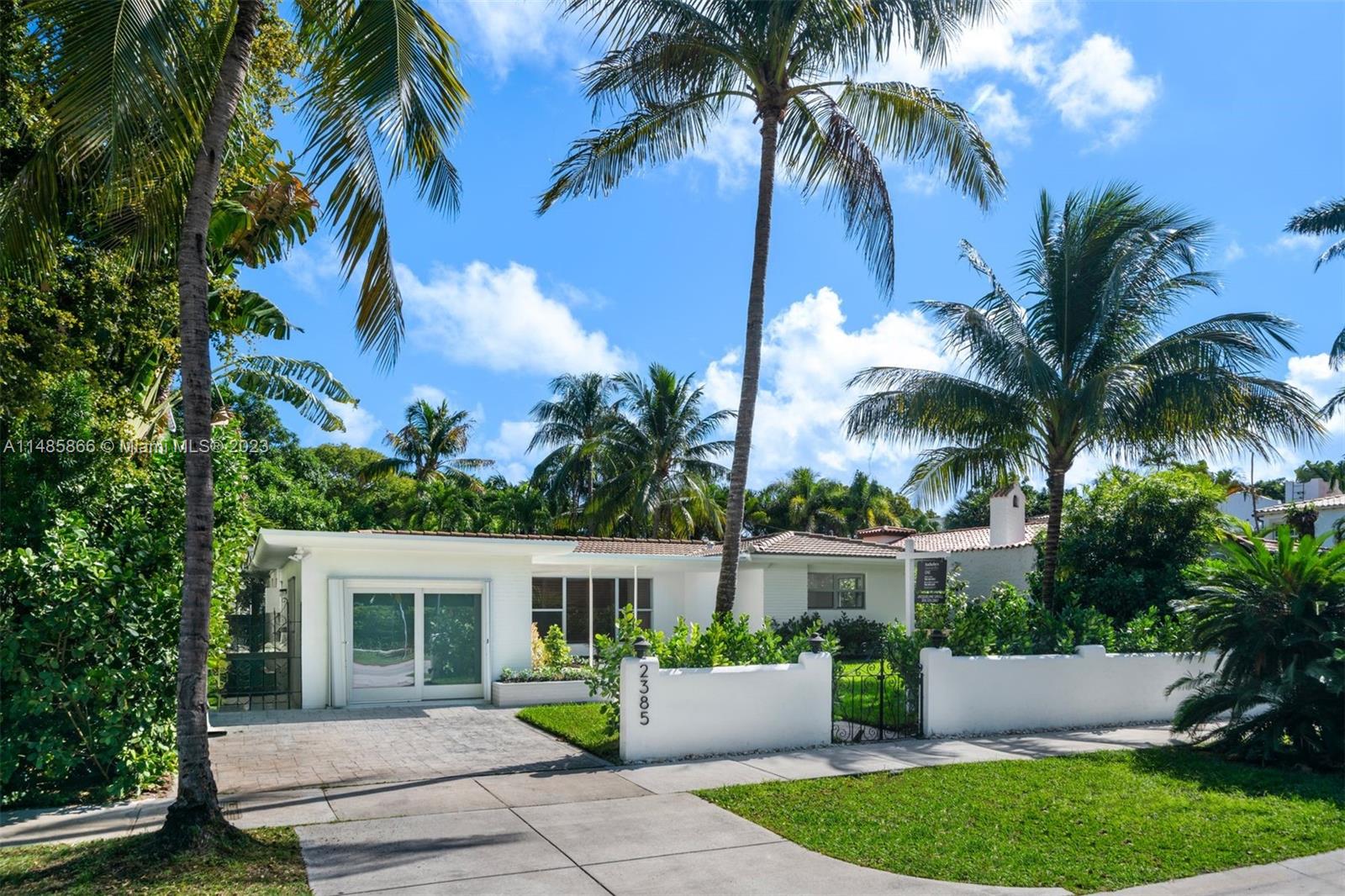2385 North Bay Road Miami Beach, FL 33140 - Photo 33 of 36 a front view of house with yard and green space