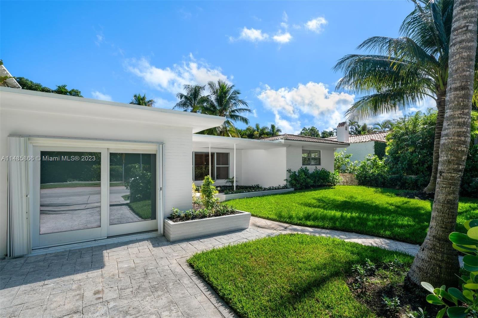 2385 North Bay Road Miami Beach, FL 33140 - Photo 34 of 36 a front view of a house with garden and porch