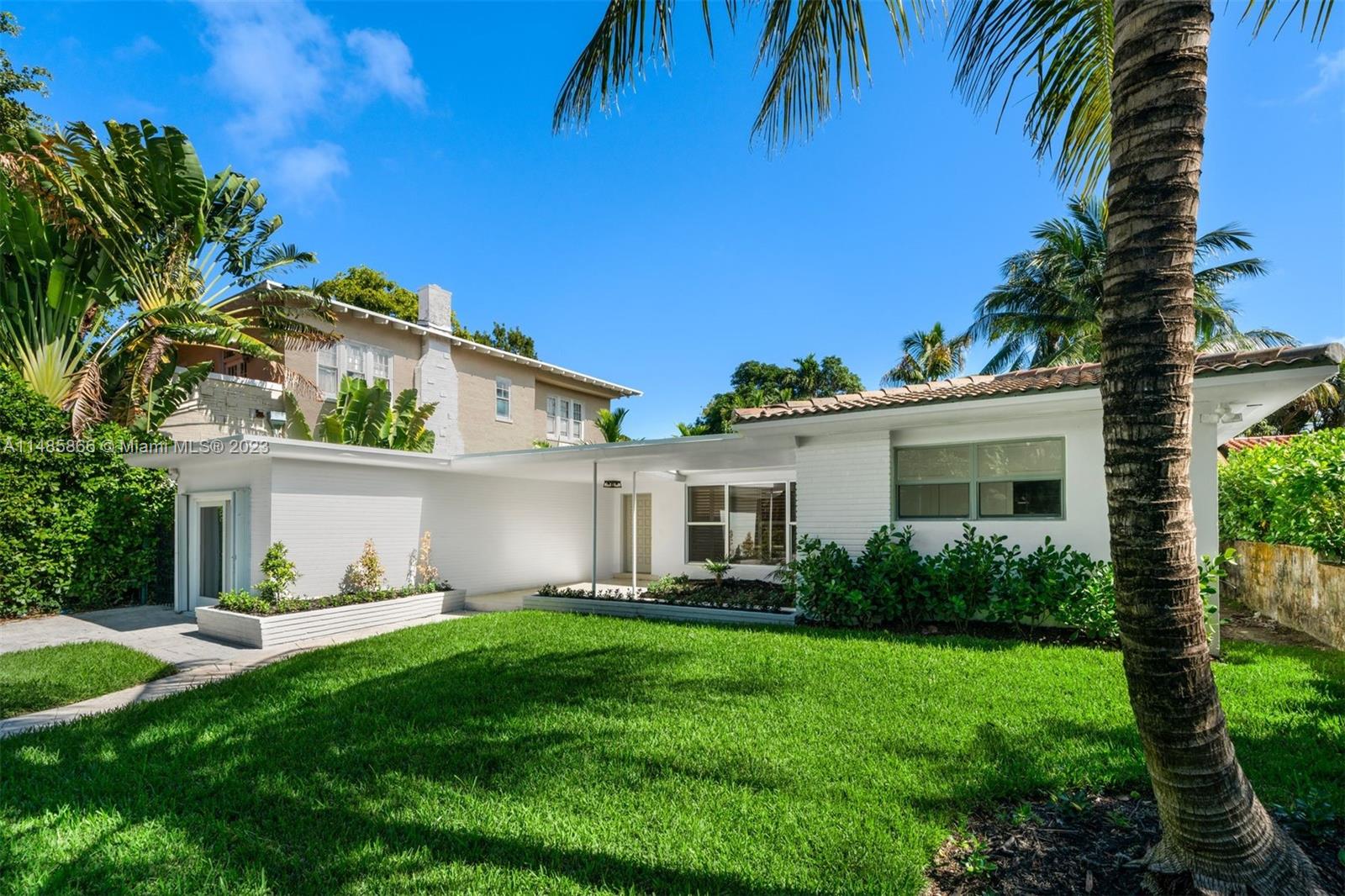 2385 North Bay Road Miami Beach, FL 33140 - Photo 35 of 36 a front view of house with yard and green space