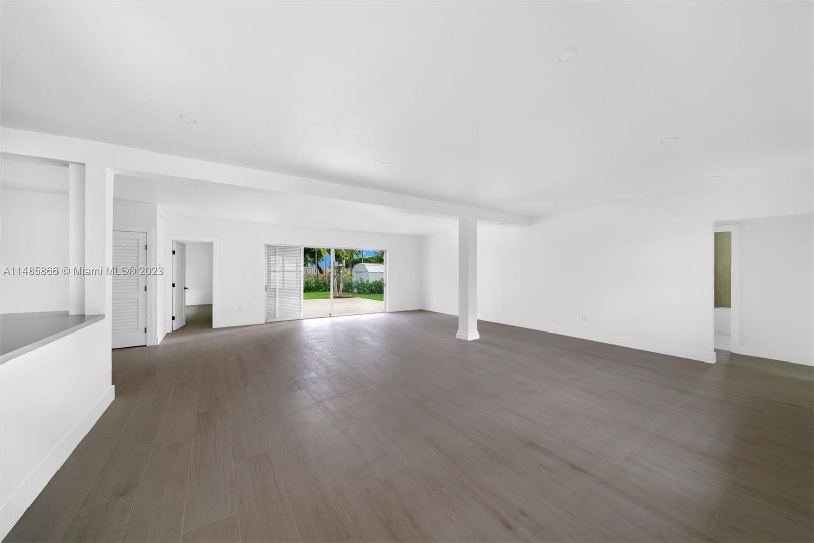 2385 North Bay Road Miami Beach, FL 33140 - Photo 4 of 36 a view of a livingroom with wooden floor and a window