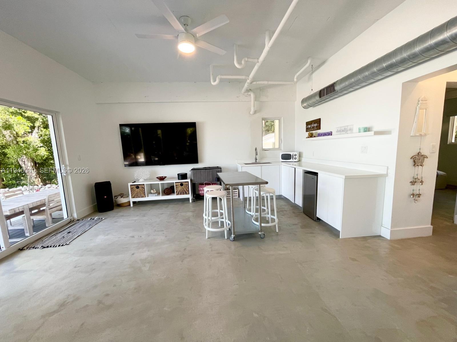 96180 Overseas Highway, Unit 1 Key Largo, FL 33037 - Photo 11 of 83 a view of a livingroom with furniture and a flat screen tv