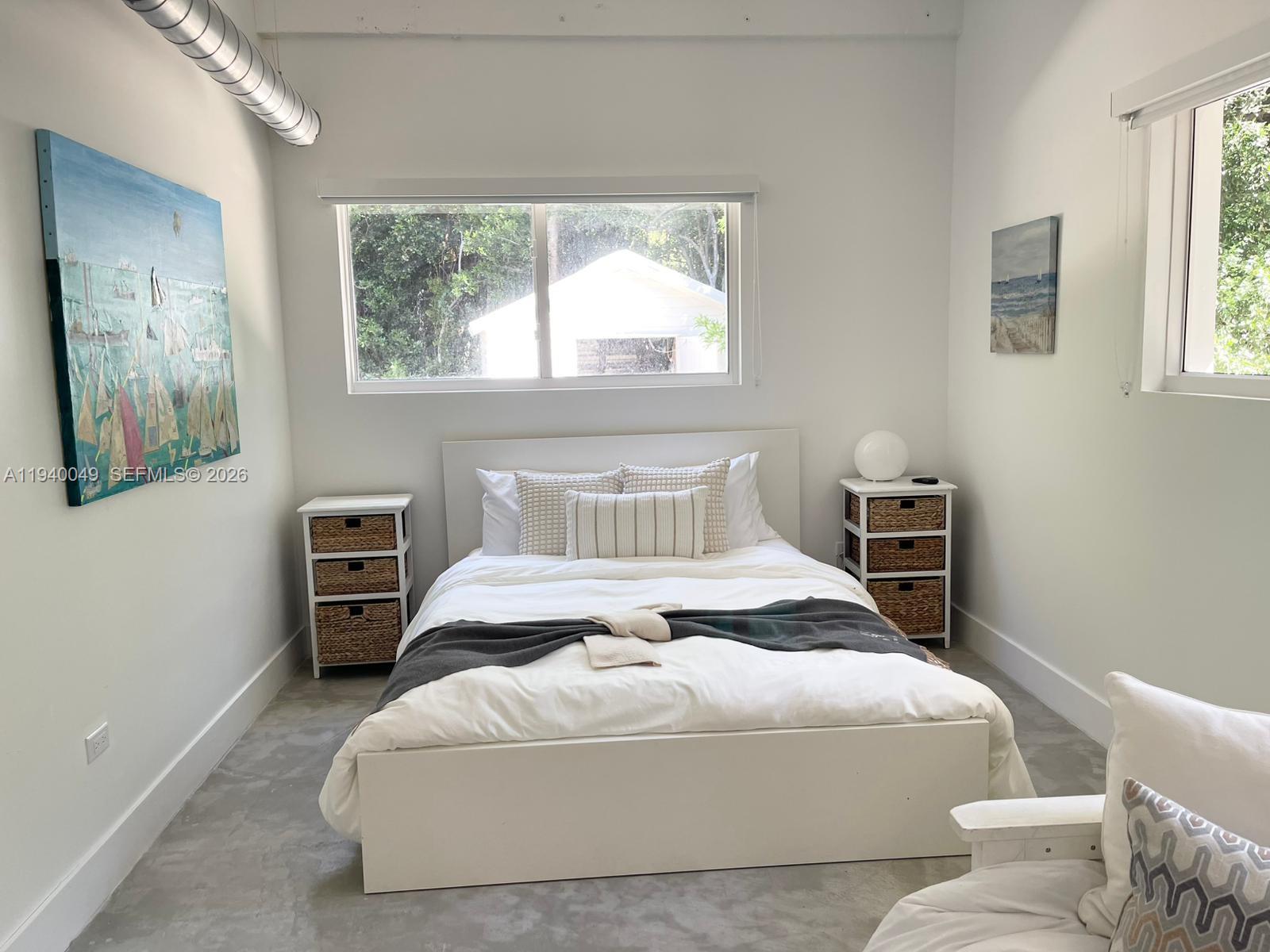 96180 Overseas Highway, Unit 1 Key Largo, FL 33037 - Photo 17 of 83 a bedroom with a large bed and wooden floor