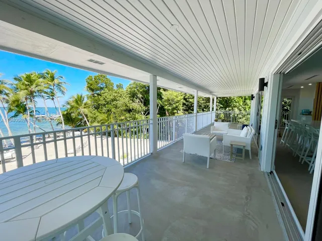 a bedroom with a bed and a view of balcony