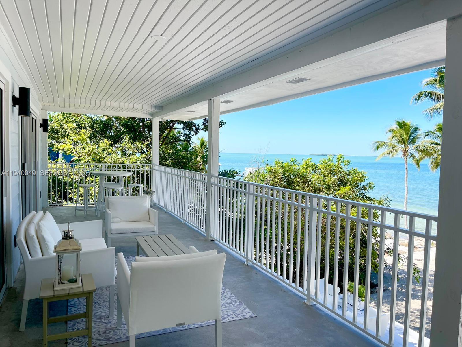96180 Overseas Highway, Unit 1 Key Largo, FL 33037 - Photo 2 of 83 a view of a porch with furniture