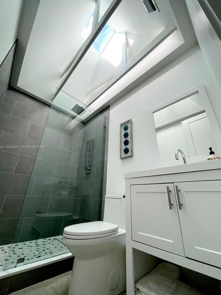 96180 Overseas Highway, Unit 1 Key Largo, FL 33037 - Photo 25 of 83 a bathroom with a toilet and a shower